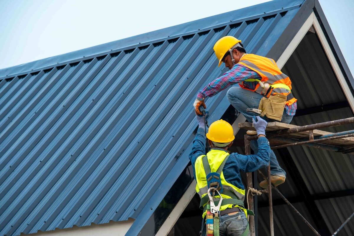 two workers on roof, insurance for roofing company